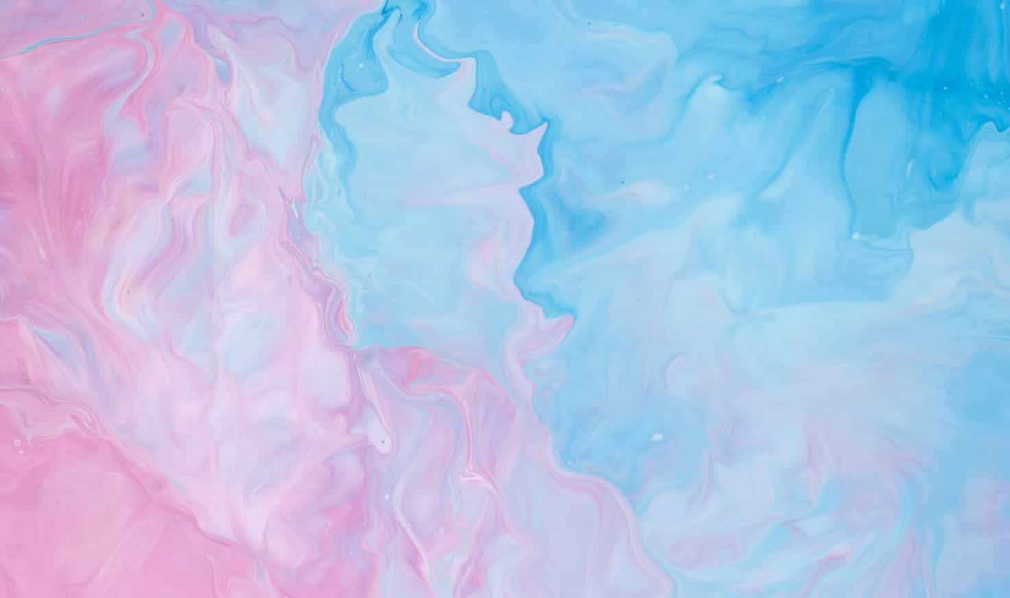 Iridescent ripples of a bright blue and pink liquid